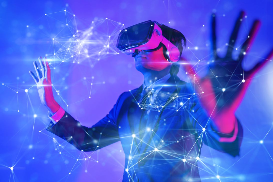 A man in a suit wears a VR headset.