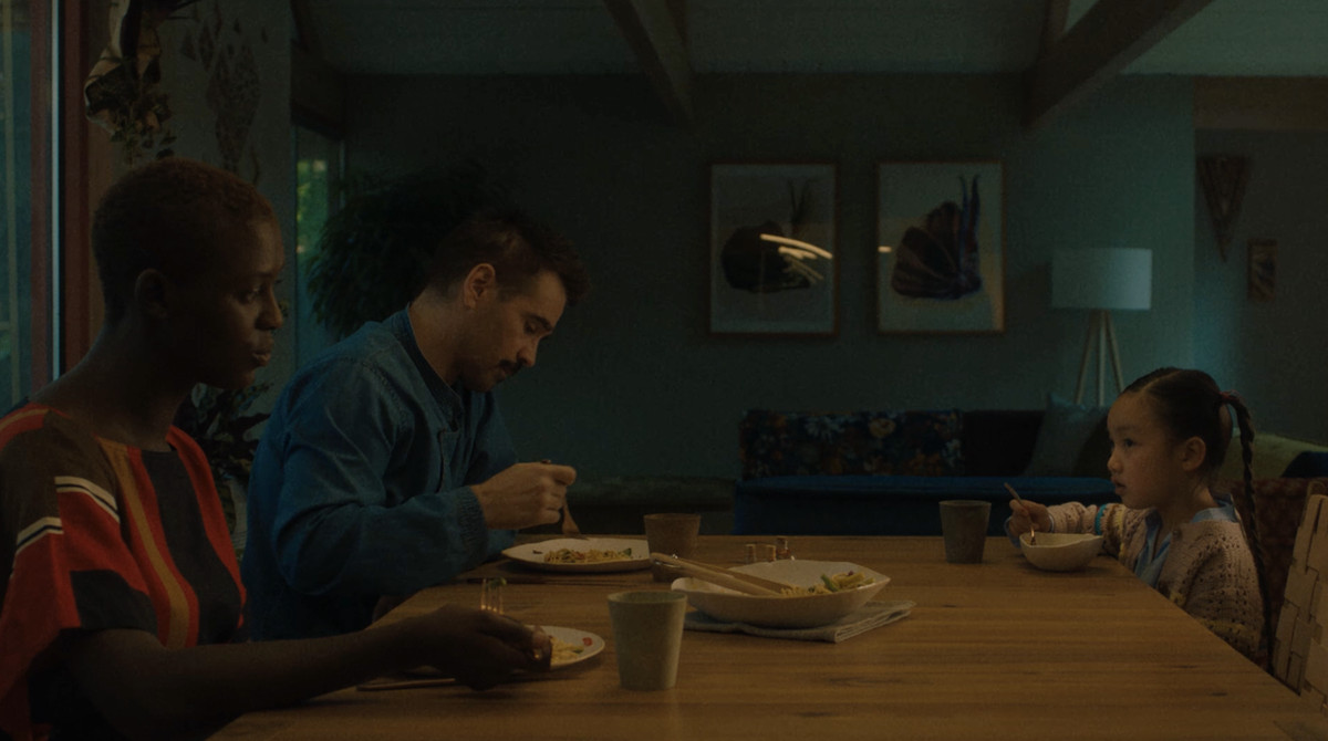 Kyra, Jake, and Mika discussing Yang’s fate over dinner at the dinner table.