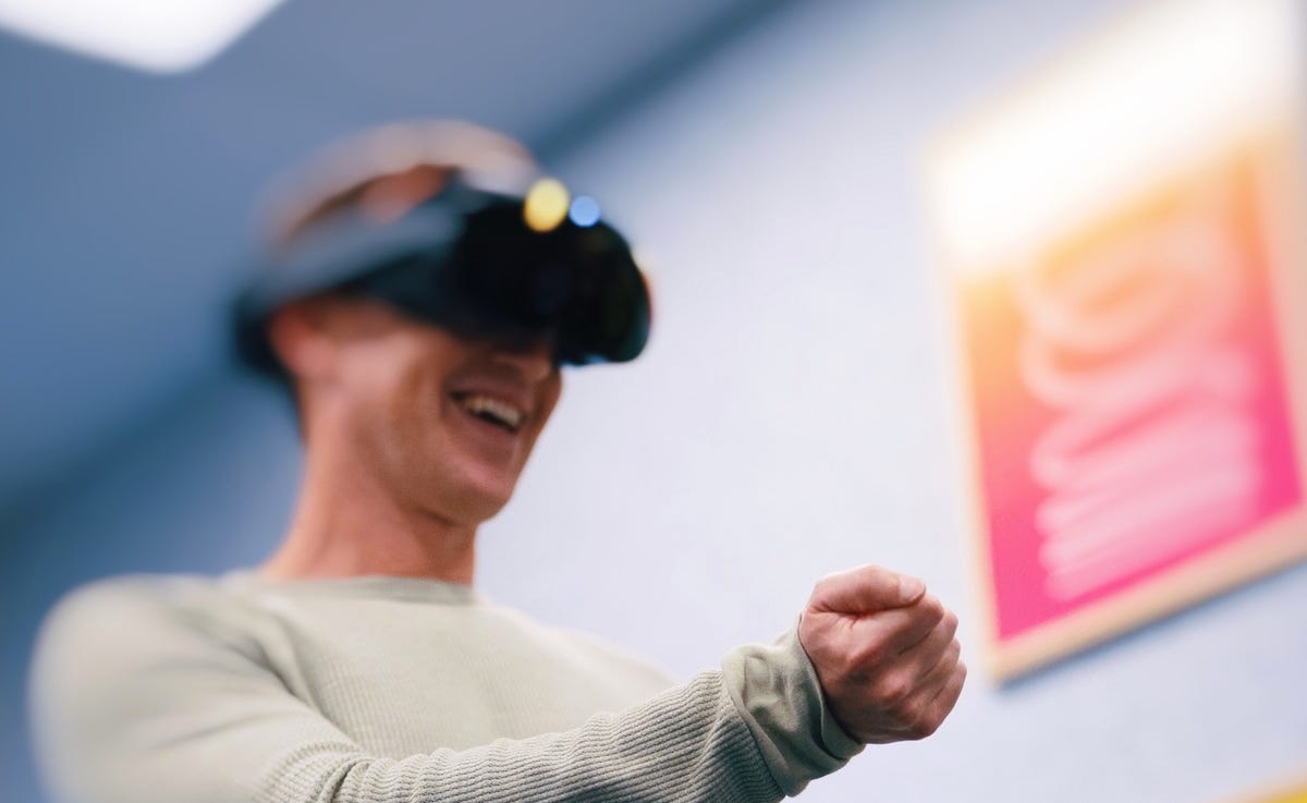 Mark Zuckerberg wearing headset and smiling while trying Meta Cambria