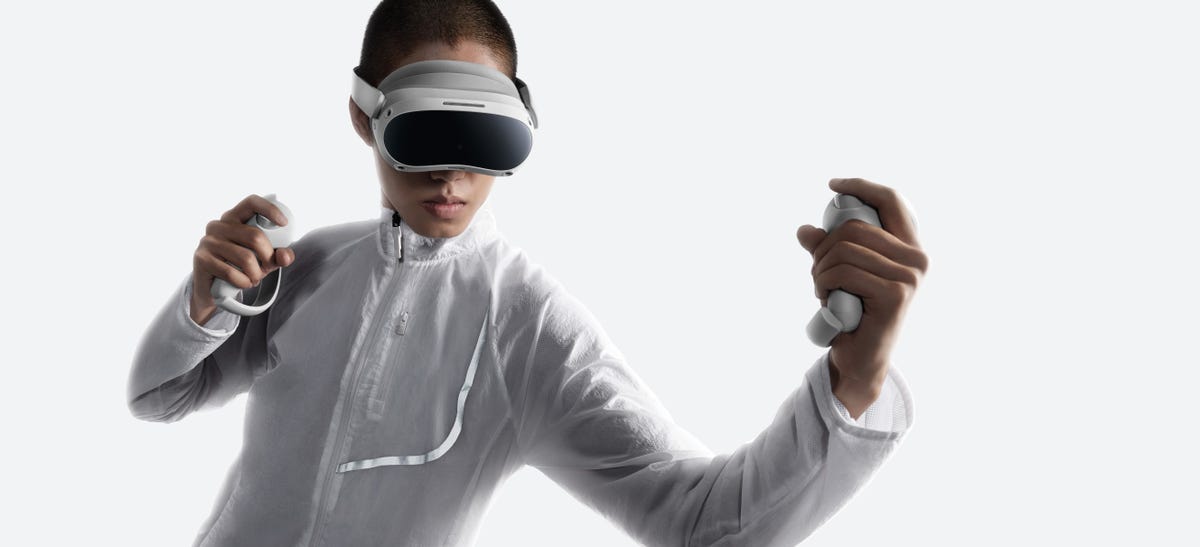 Someone in a white shirt using the Pico 4 headset