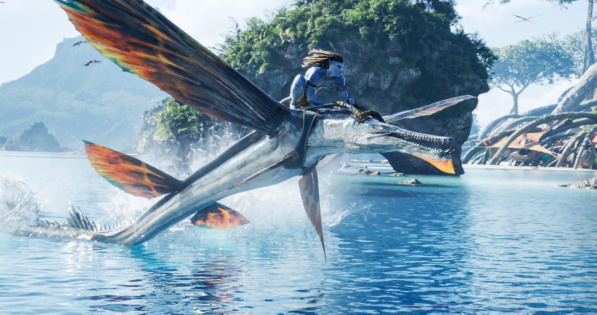 Jake Sully flies over Pandora's waters on a winged creature's back in Avatar: The Way of Water