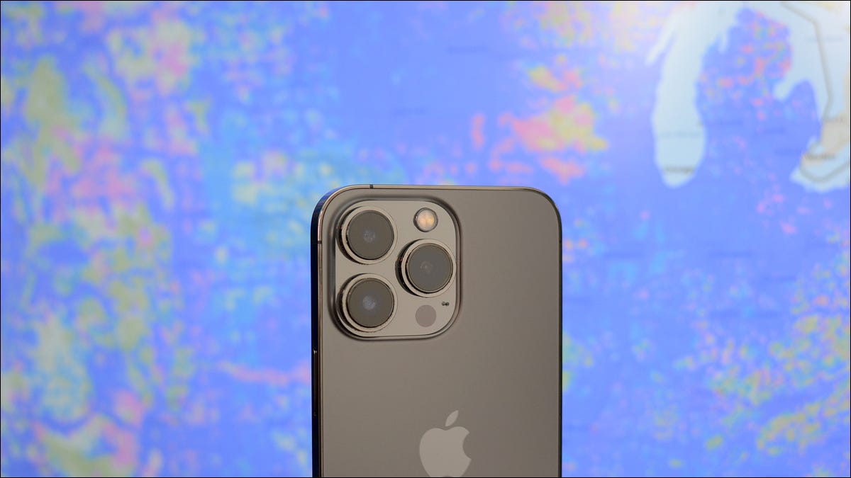 A smartphone held in front of a cellular rollout map.