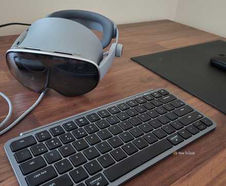 Samsung Galaxy XR headset next to a Bluetooth keyboard and mouse.