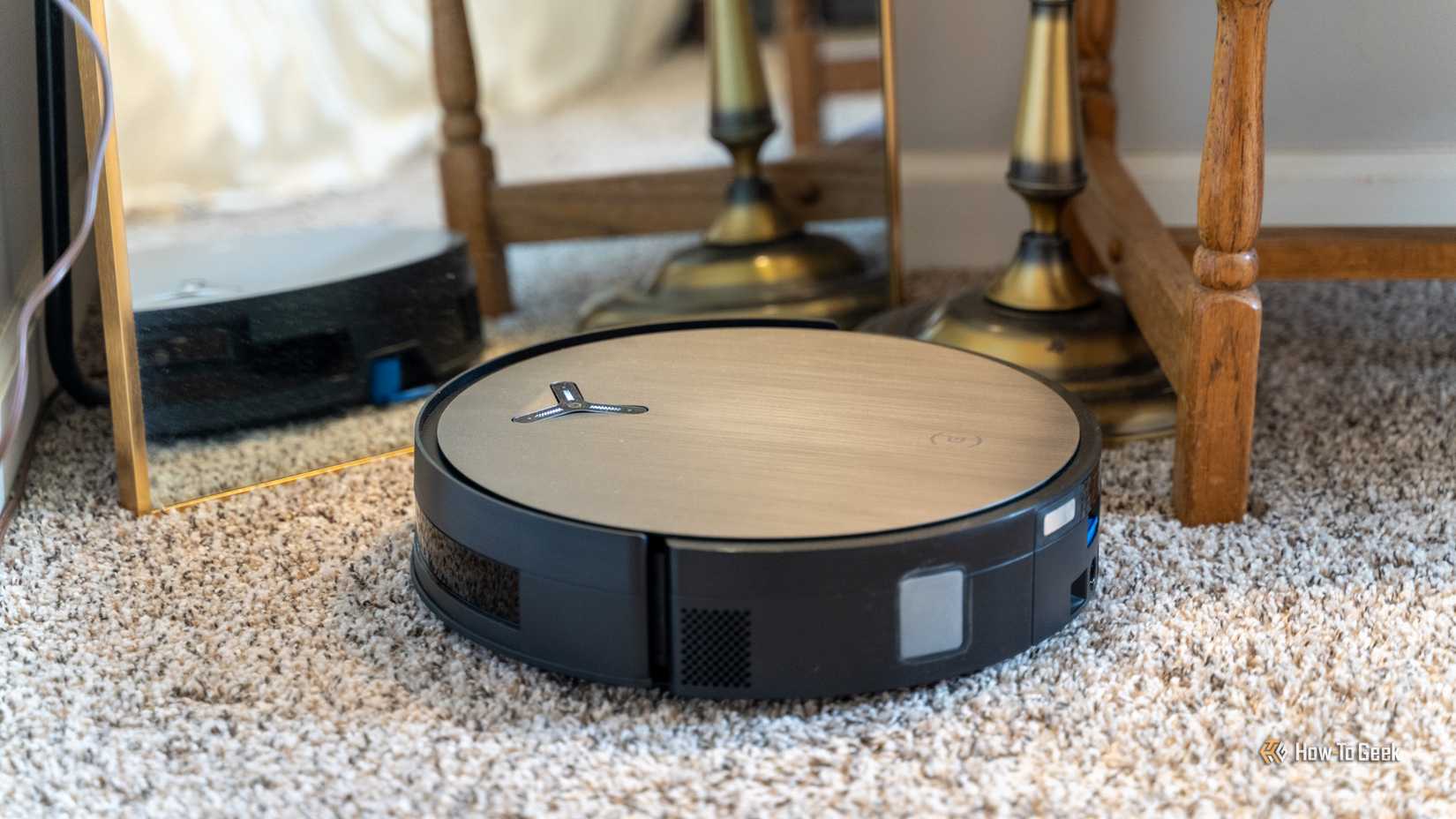 The Deebot X11 Omnicyclon robot vacuum in front of a mirror to show that it can map even with reflective objects.